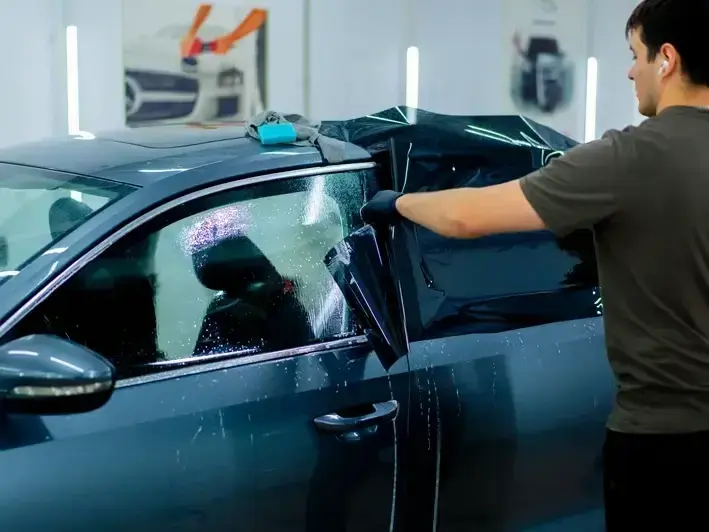 Certified technician inspecting windshield crack and camera area on an Eastside commuter car in Totem Lake Kirkland