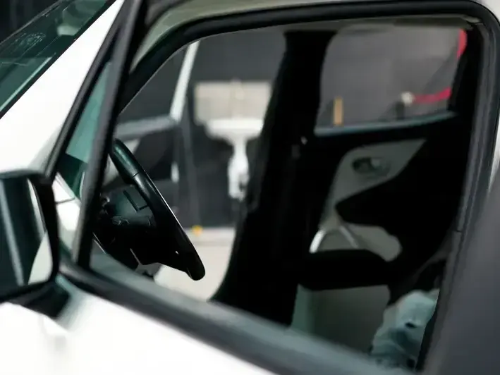 rock chip repair on sedan windshield parked by Bellevue Square office area